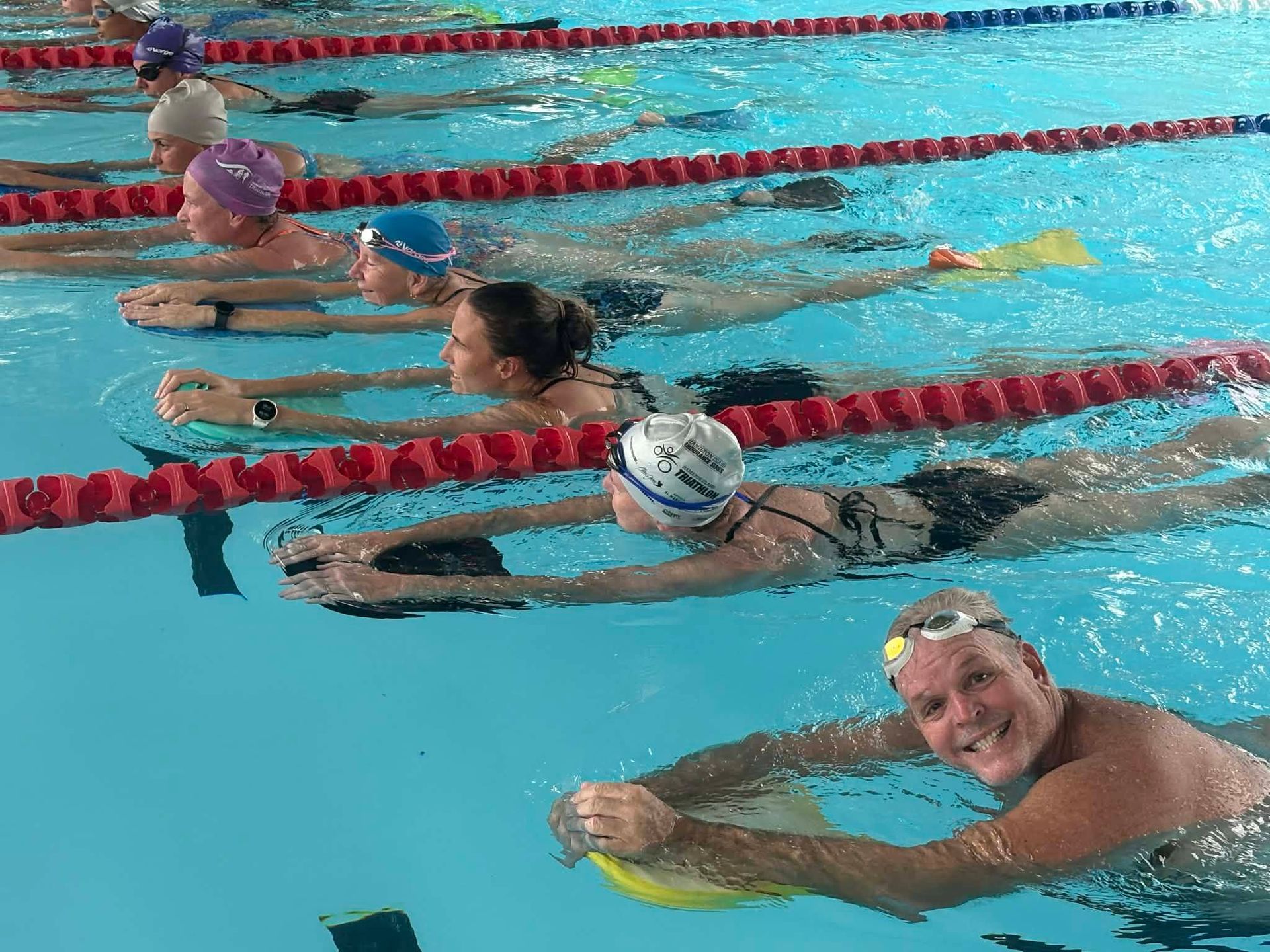 Swimmers in a Pool, Some Using Kickboards, Swimming Laps — Cannonvale Swim Centre In Cannonvale, QLD