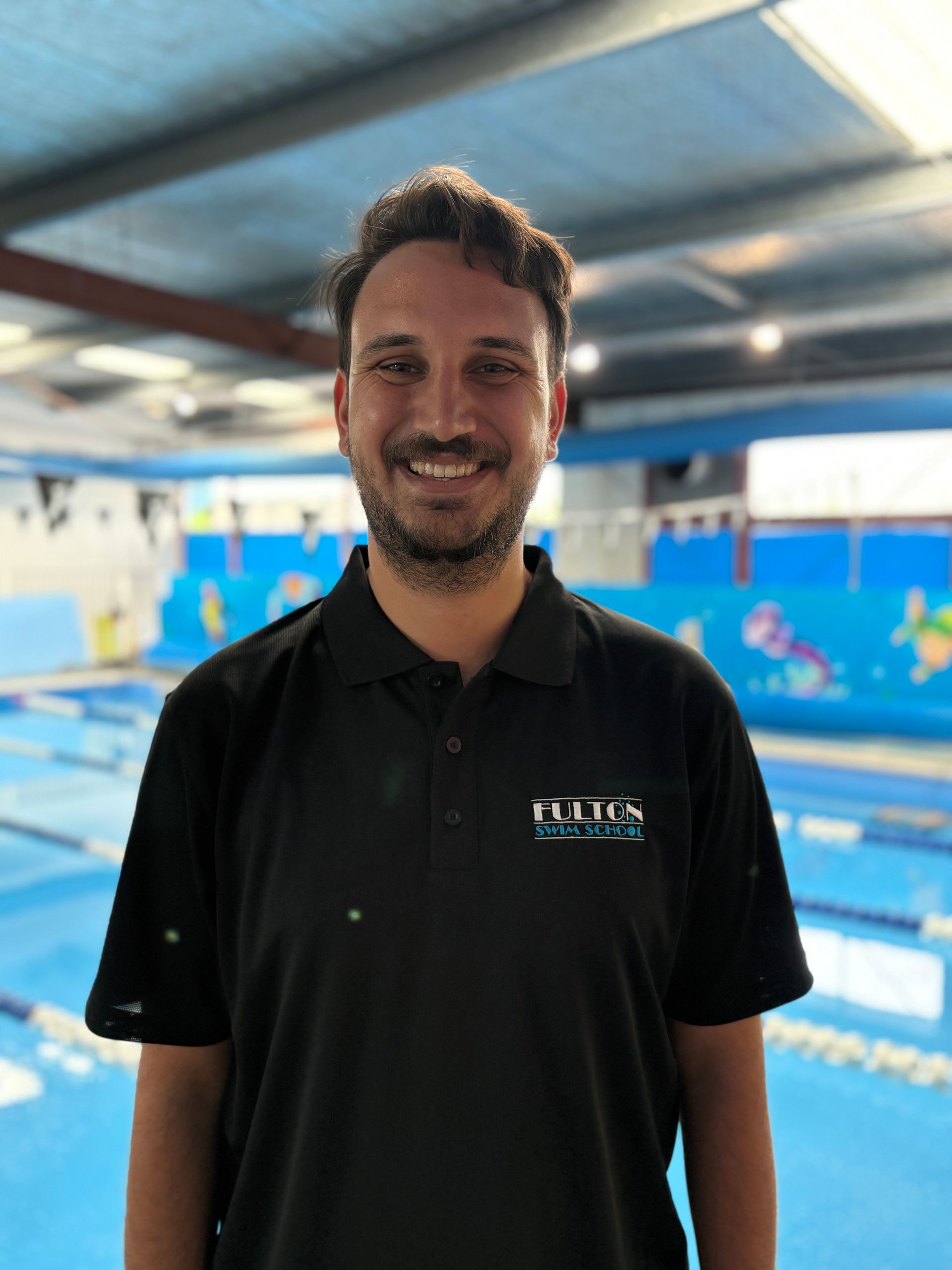 Our manager smiling at the swimming pool