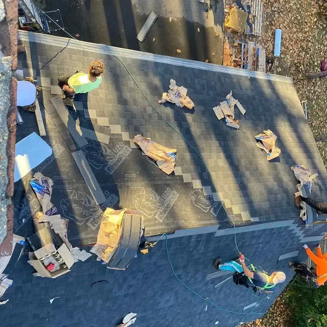 A group of people are working on a roof.