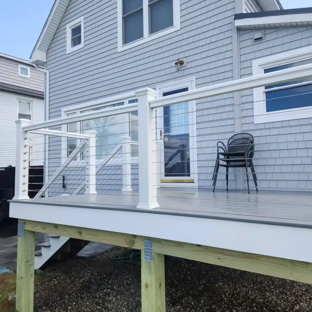 A house with a deck and stairs in front of it