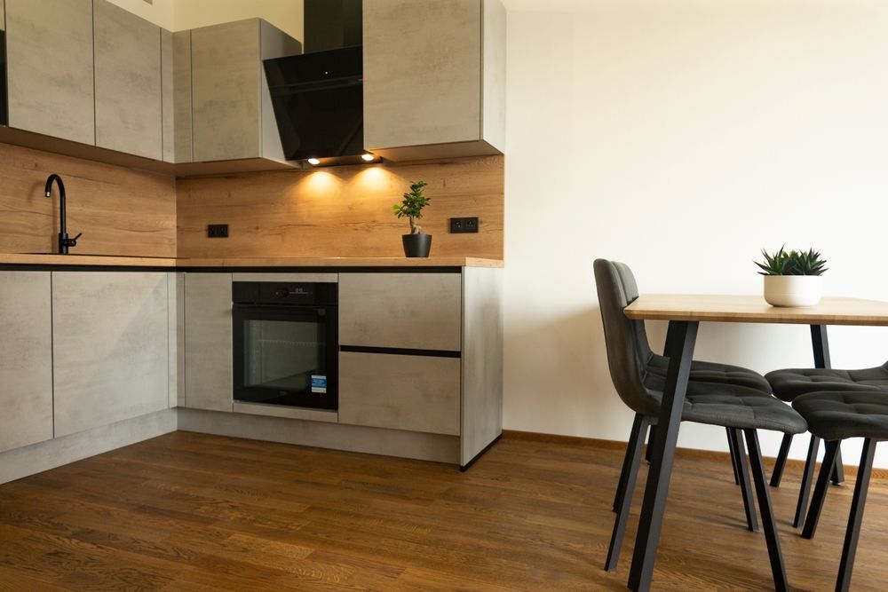 A kitchen with a table and chairs in it.