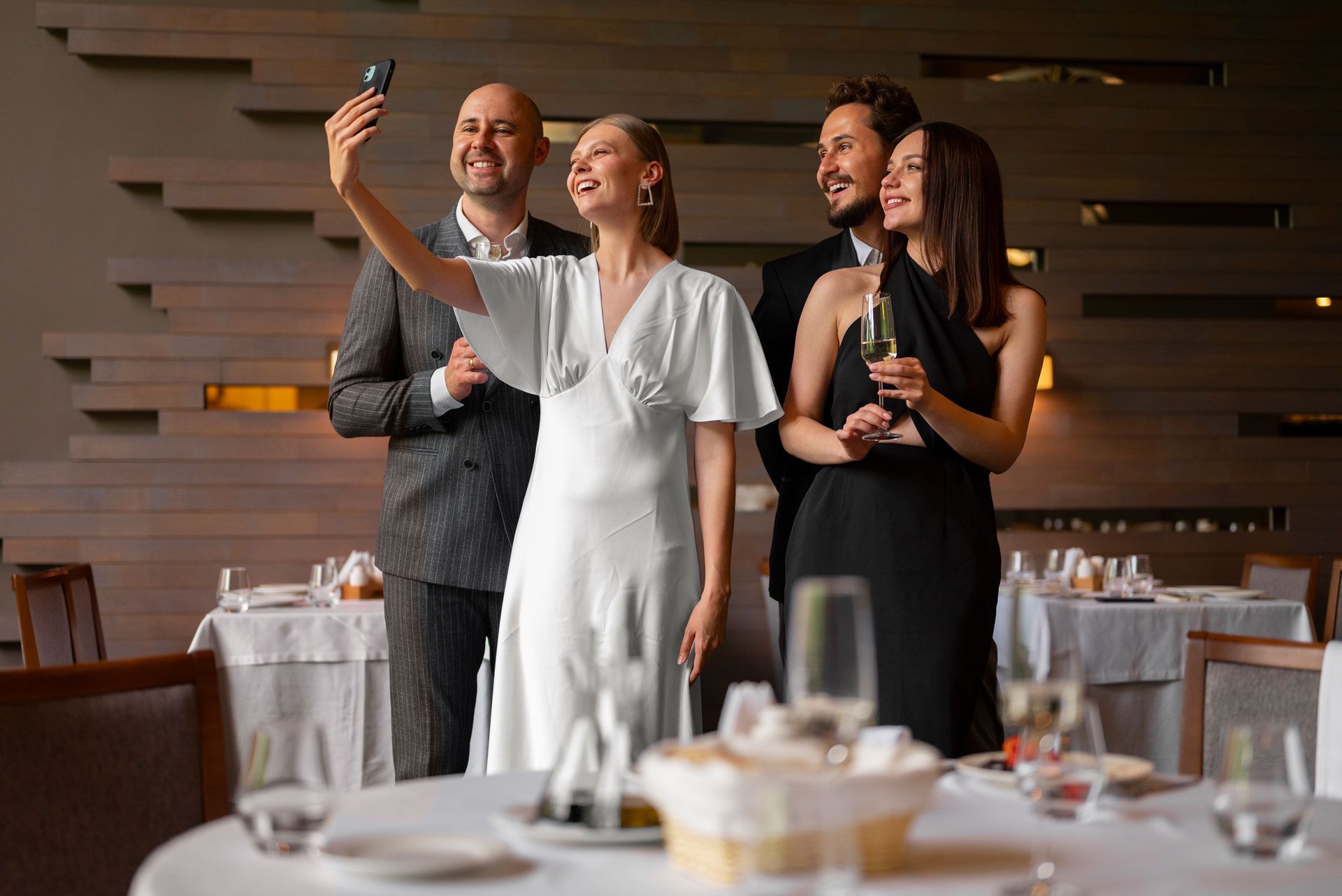 A group of people are taking a selfie in a restaurant.