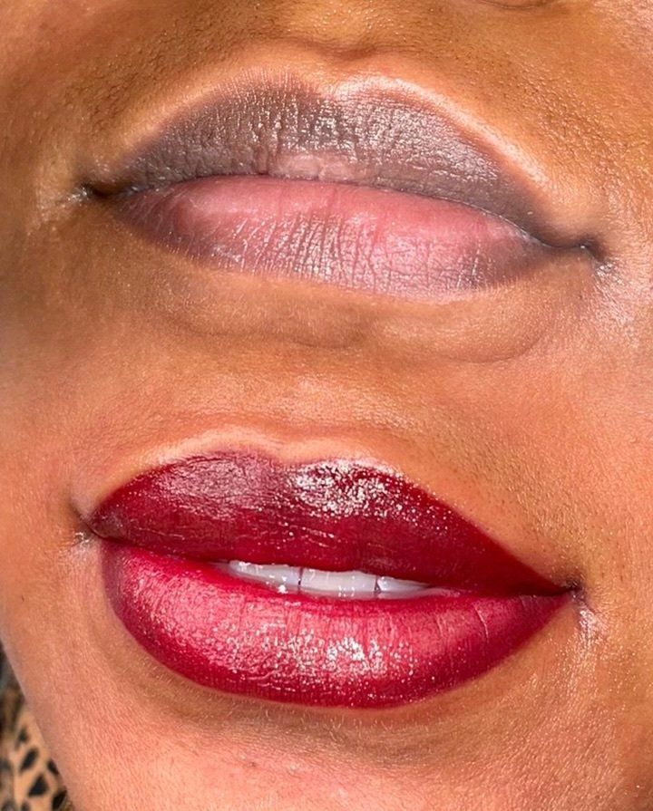 Comparison of lips before and after lip blushing: upper lips are dark, lower are red.