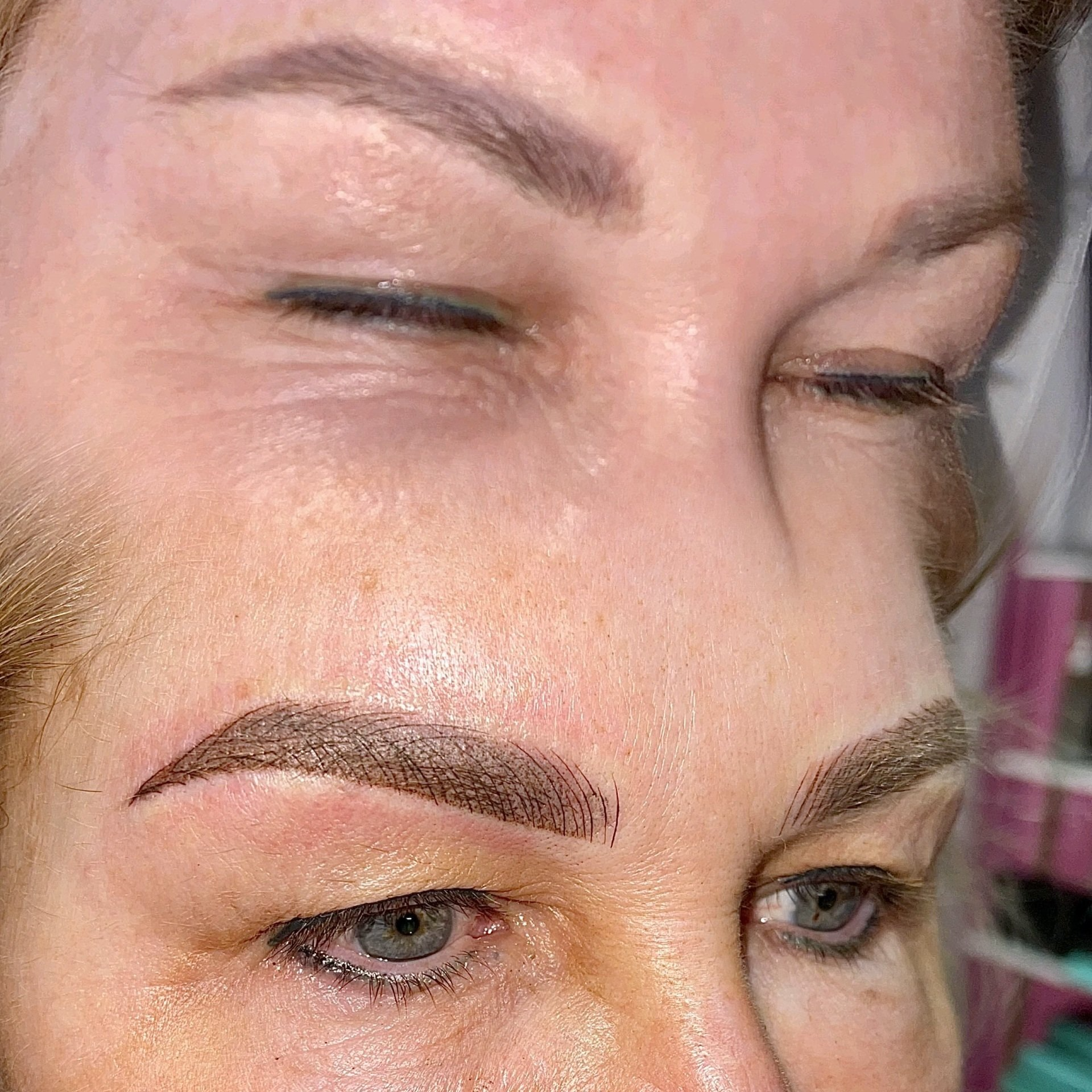 Close-up of a person's eyes, showing before and after eyebrow microblading. The eyes are closed in the top half, and open in the bottom half.