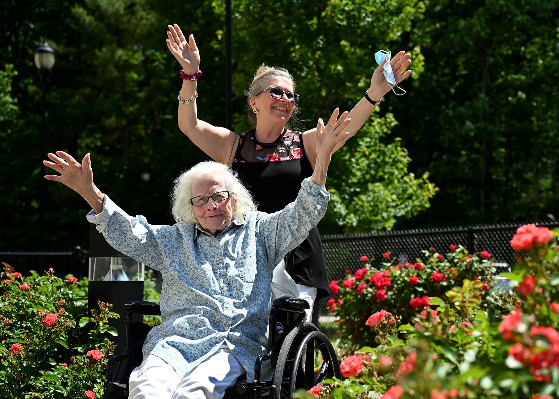 Agnes DeCenzo, 104, the last living participant in the first generation of the Framingham Heart Study, raises her arms in her signature