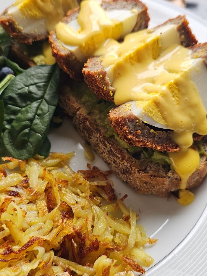 Scotch egg on Avocado toast with spinach salad