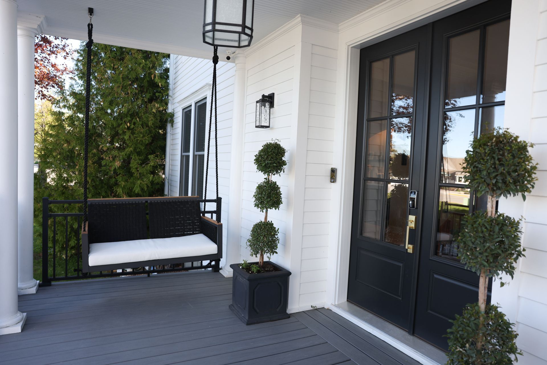 Entrance with topiary and porch swing