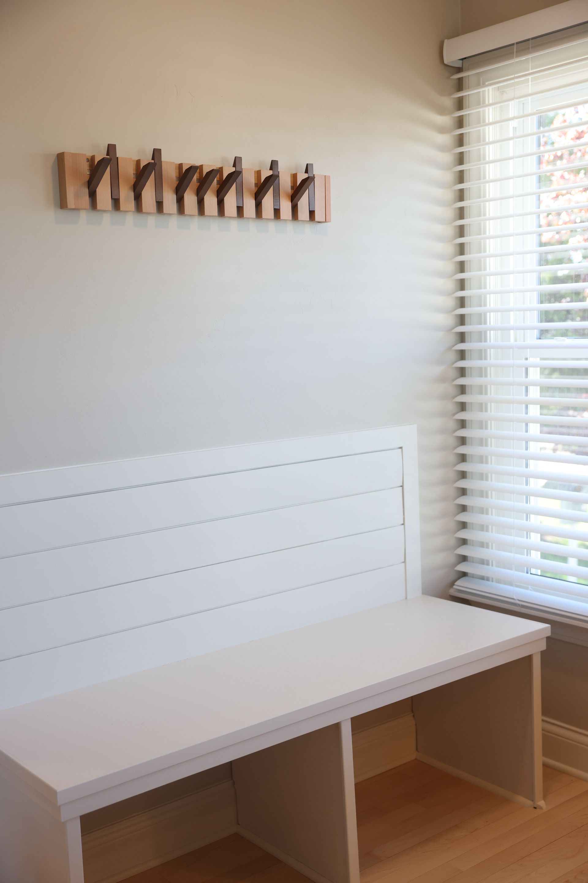 Hooks and bench in Golden room