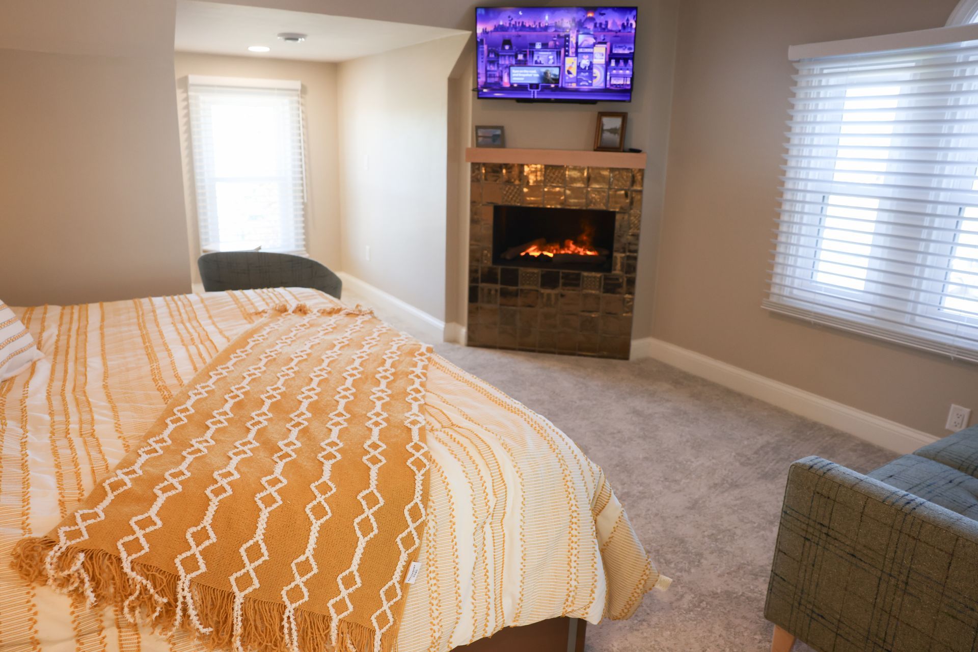 A bedroom with a bed , dresser , and ceiling fan.