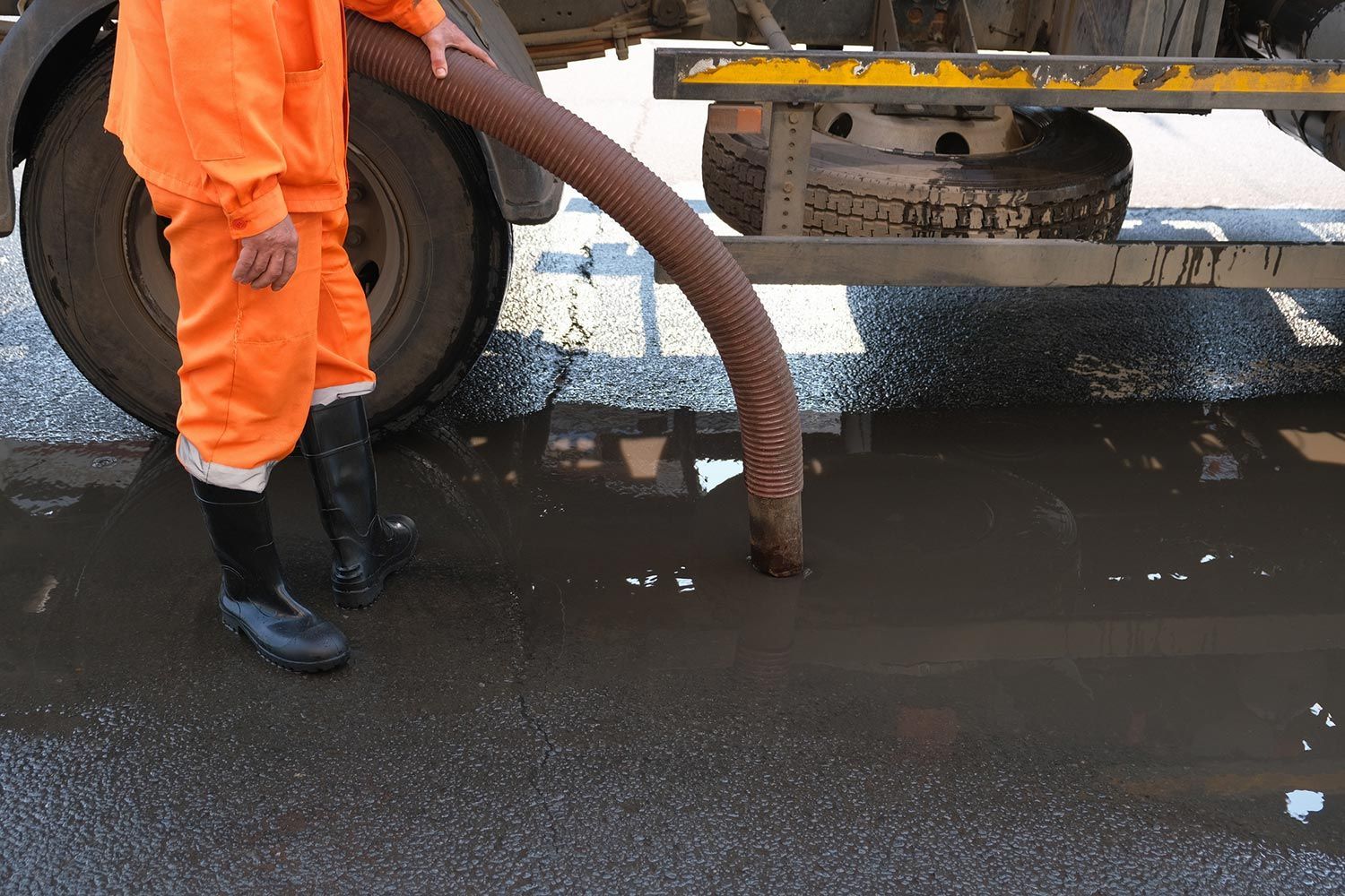 Worker Cleaning the Drainage — Gulfport, MS — Vacuum Services