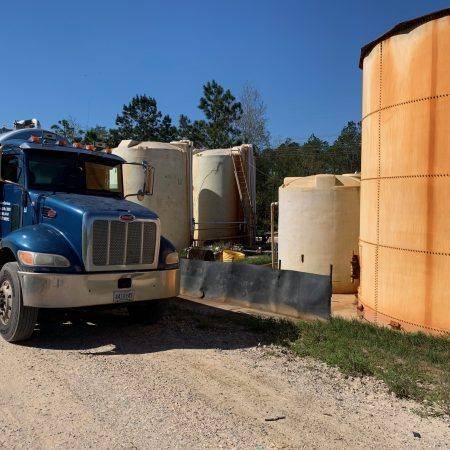 Blue Truck and Row of Large Tanks — Gulfport, MS — Vacuum Services