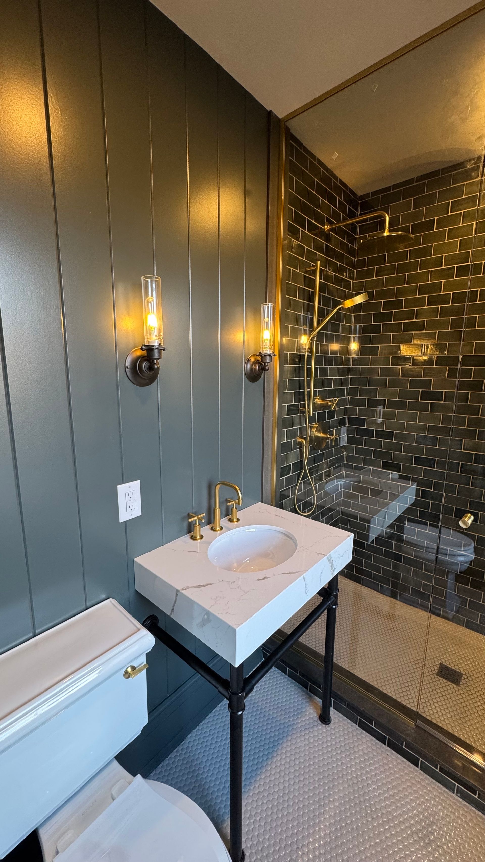 A bathroom with a sink , toilet and shower.