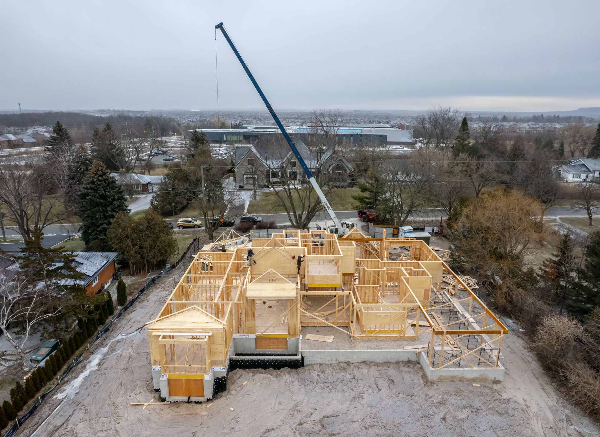 An aerial view of a large wooden house under construction.