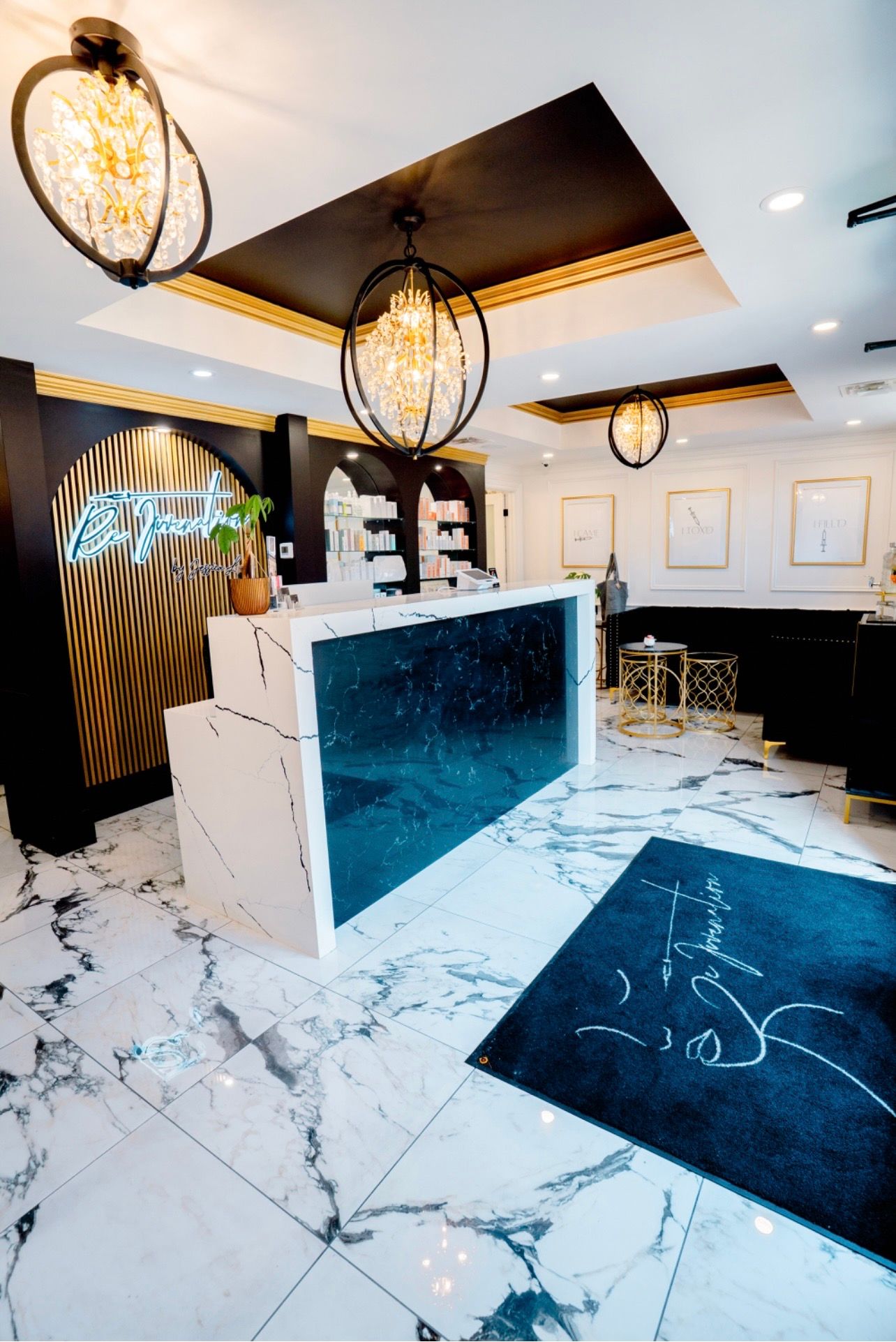 A hotel lobby with a marble floor and a blue counter.