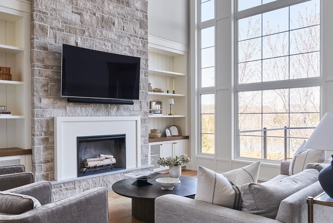 A living room with a fireplace and a flat screen tv.