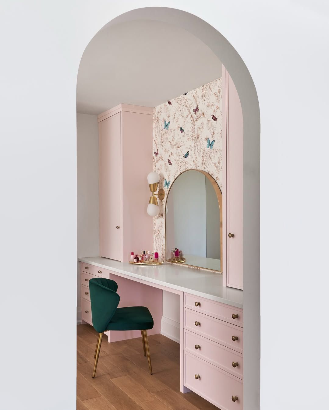 A room with a desk , chair , and mirror.