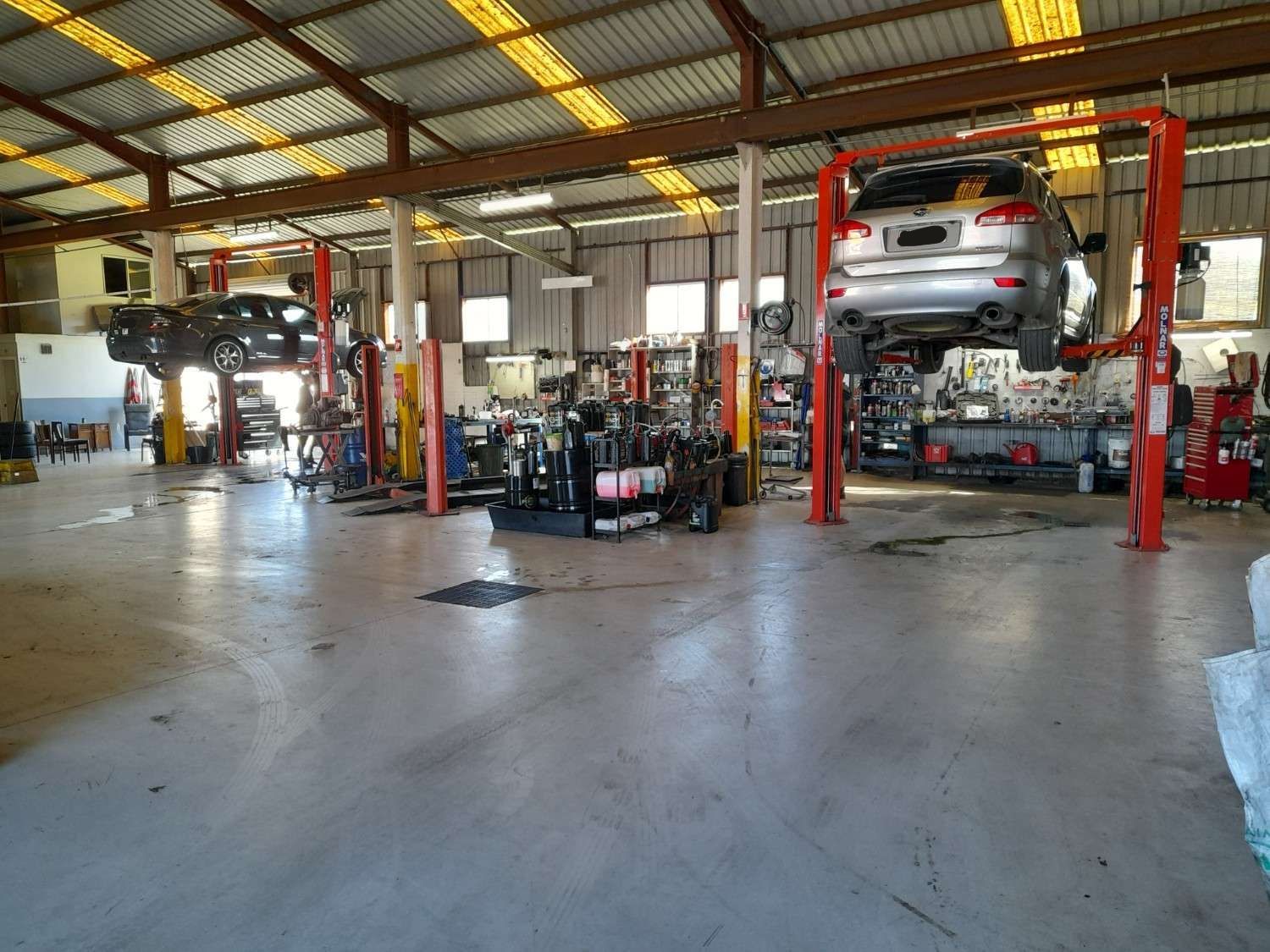 A Car Is Sitting on A Lift in A Garage — All Mechanical Services in South Murwillumbah, NSW