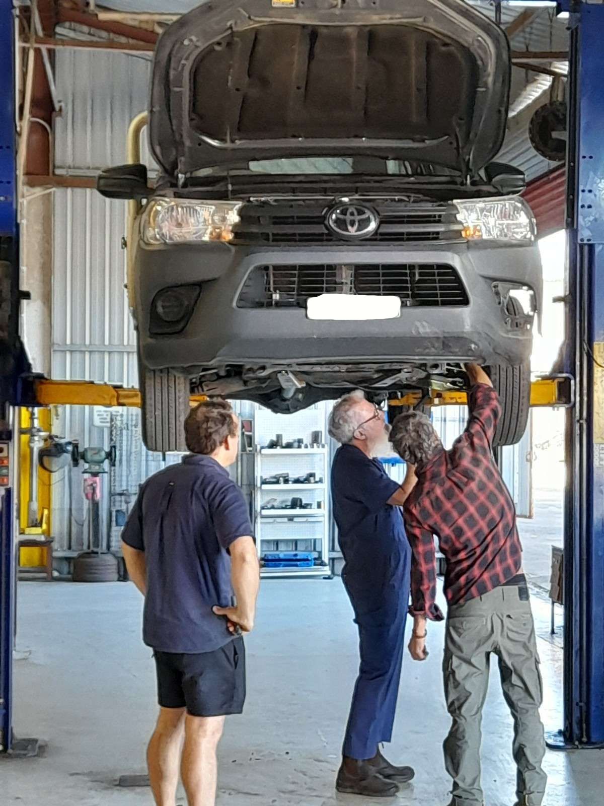 A Car Is Sitting on A Lift in A Garage — All Mechanical Services in South Murwillumbah, NSW