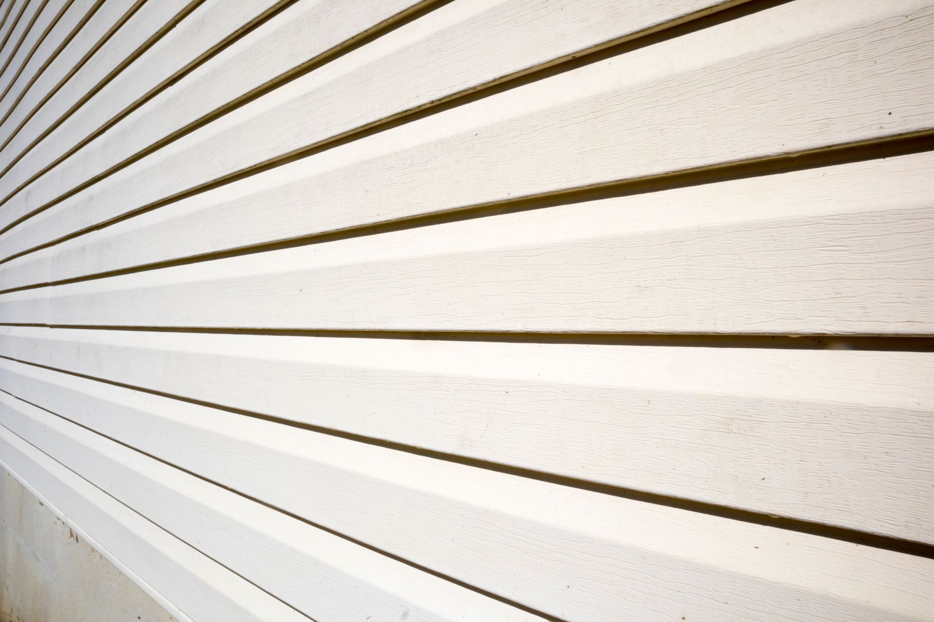 Diagonal white siding panels with brown gaps forming strong perspective lines