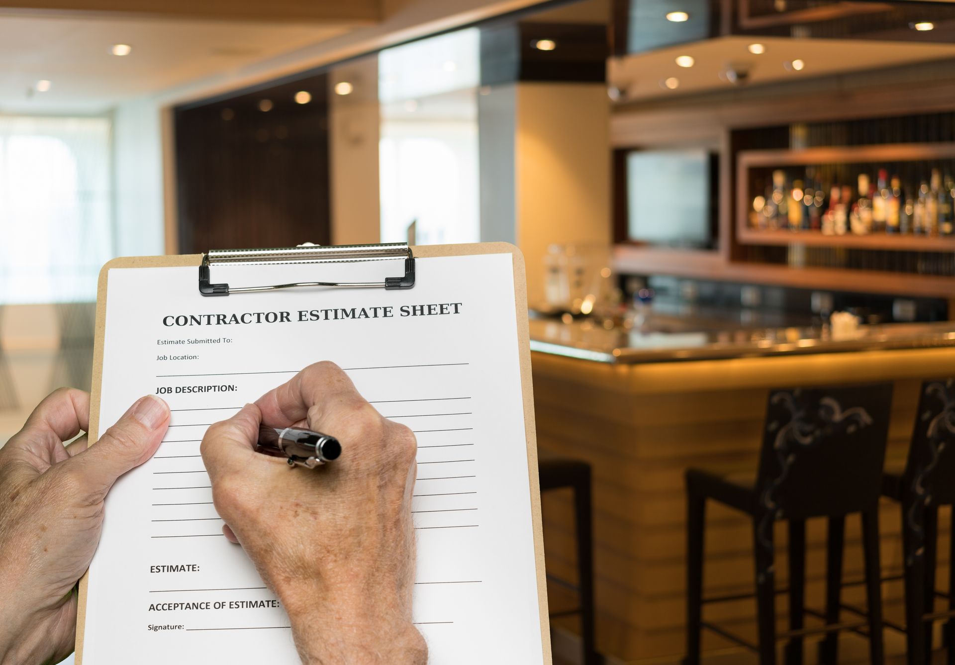 Contractor filling out a budget estimate for a restaurant commercial remodeling project. Contractor filling out a budget estimate for a restaurant commercial remodeling project.