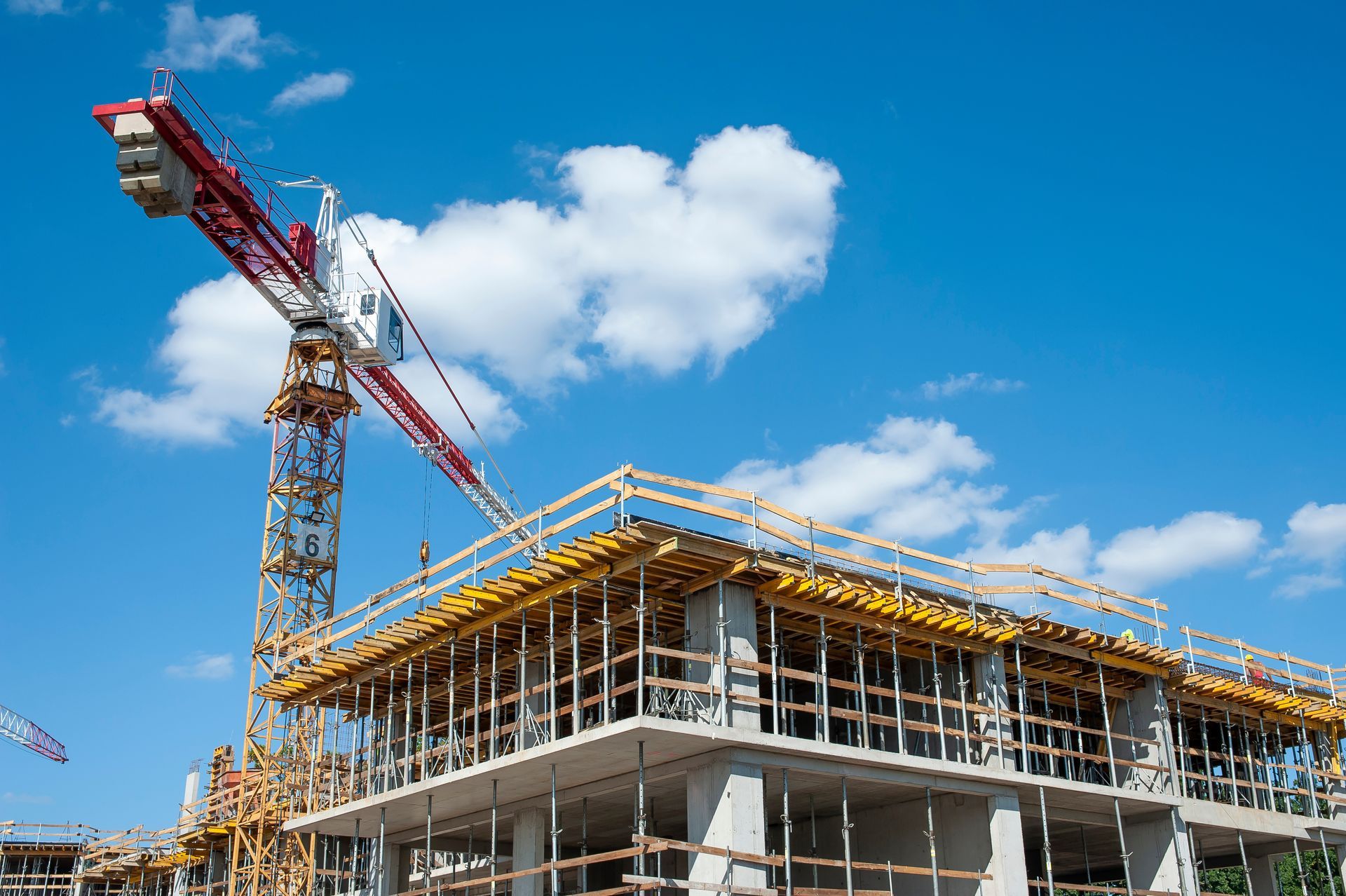 Apartment building under construction on a sunny day.