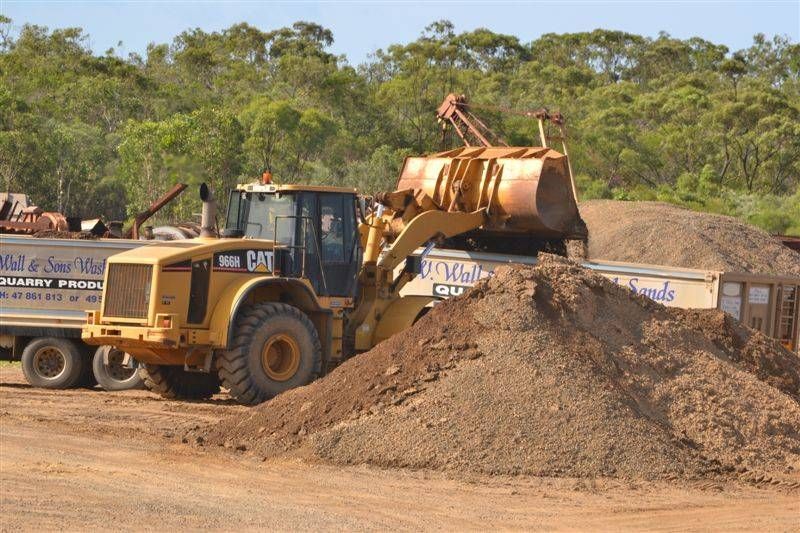 A Pile Of Gravel Is Being Poured From A Machine Into A Pile Of Gravel — W Wall & Sons In Airlie Beach, QLD