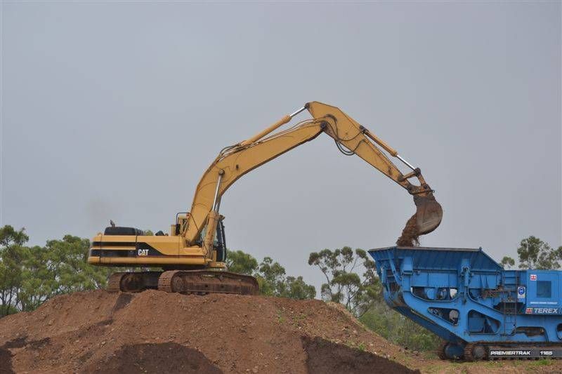 Yellow Excavator is Loading a Dump Truck in a Quarry — W Wall & Sons in Nebo, QLD