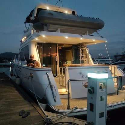 Illuminated yacht docked at a marina after detailing by Blue Moon Yacht Services