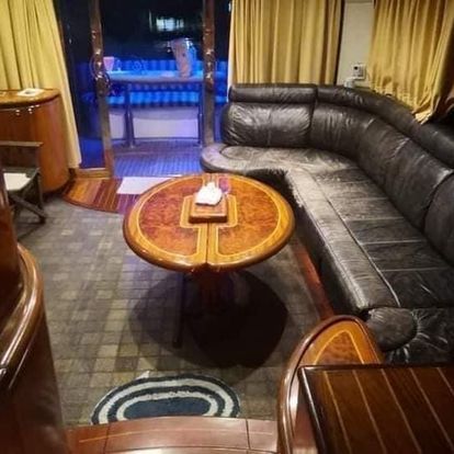A living room with a couch , table and chairs.