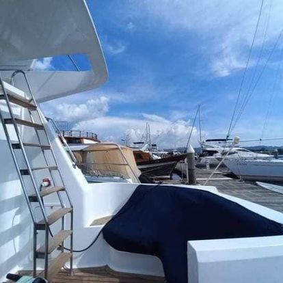 A boat is docked at a marina with boats in the background