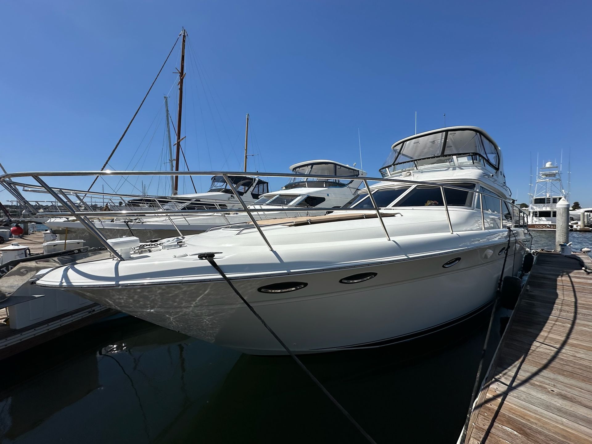 White flybridge yacht docked after cleaning and polishing