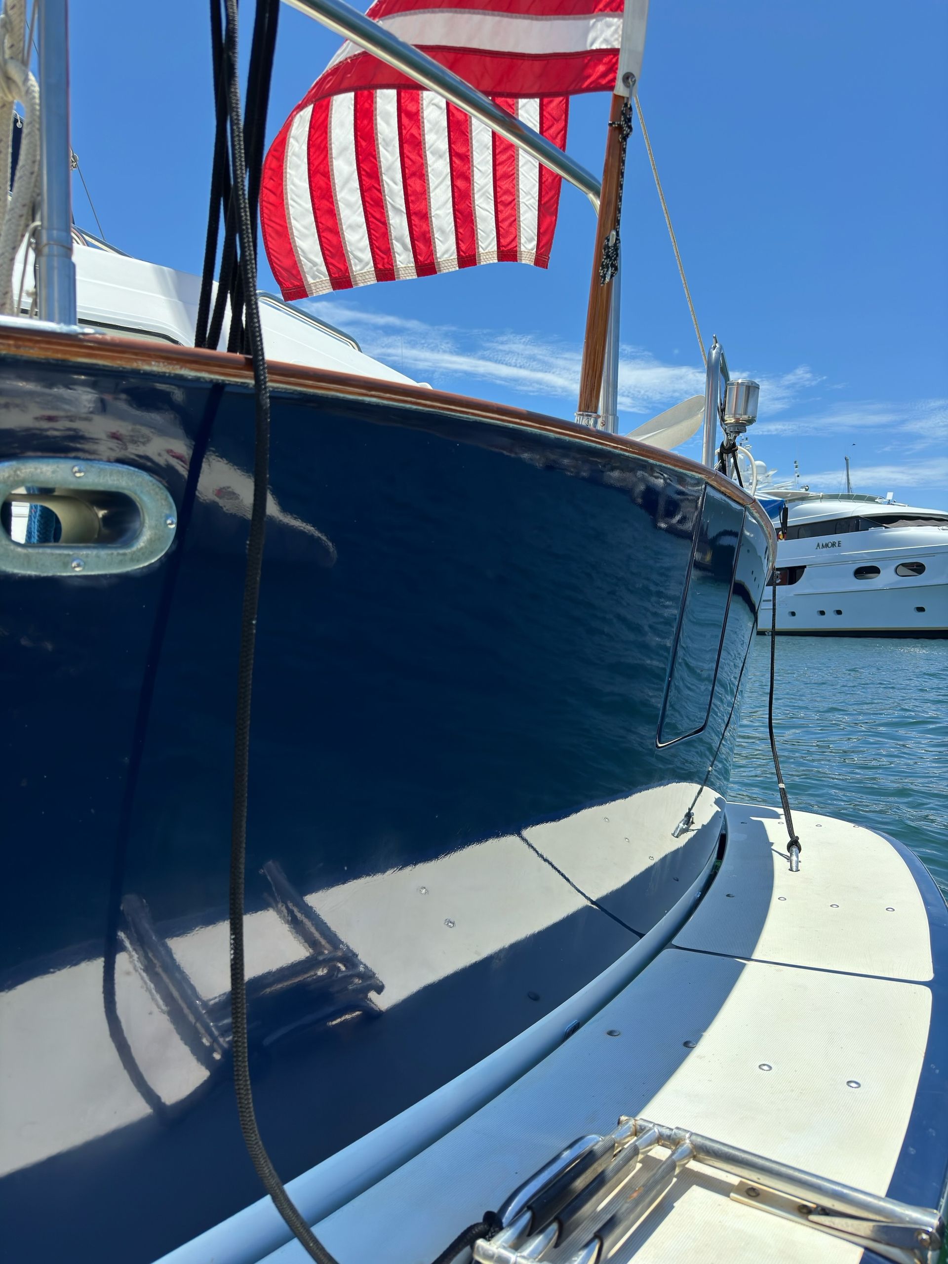 Polished blue sailboat hull at a San Diego marina