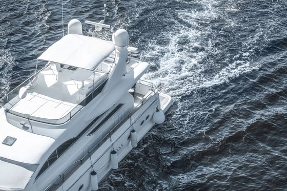A large white yacht is floating on top of a body of water