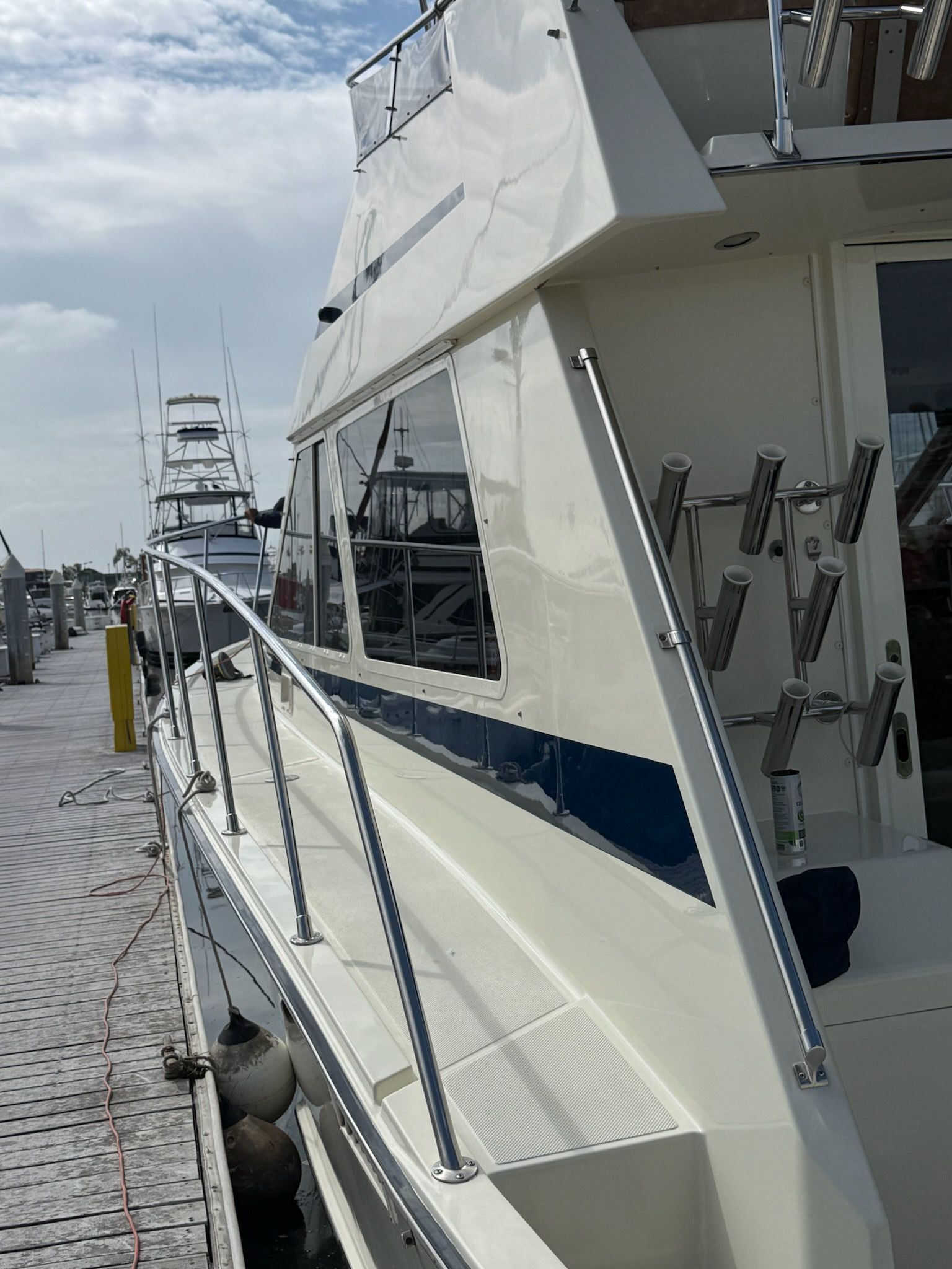 Cleaned yacht side deck with polished railings and rod holders