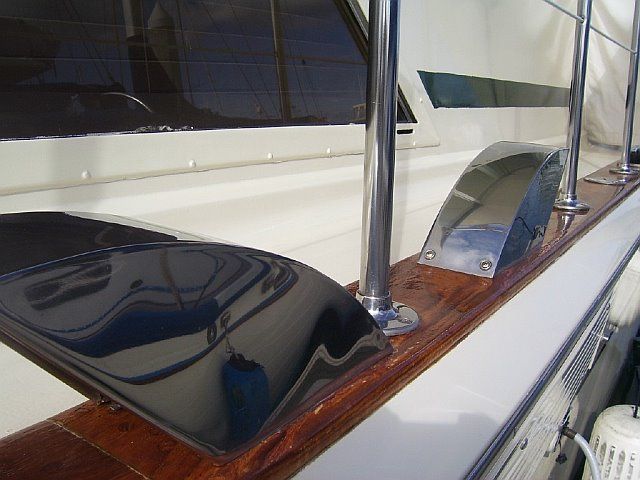 Polished stainless steel and varnished wood details on a yacht