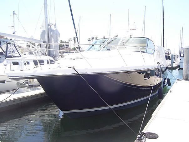 A boat is docked at a marina next to a dock.
