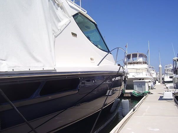 Several boats are docked at a marina on a sunny day