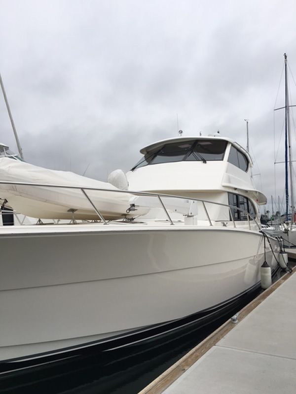 White motor yacht after exterior cleaning at a marina