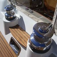 There are two winches on the side of a boat.