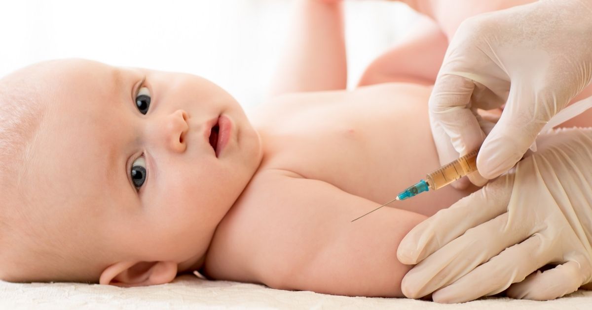 A baby is getting an immunization shot.