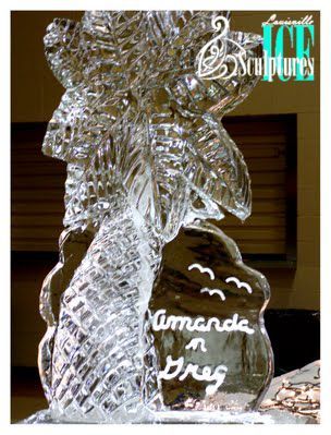 Clear ice sculpture of a person holding flowers, with “American Drug” written on the base.