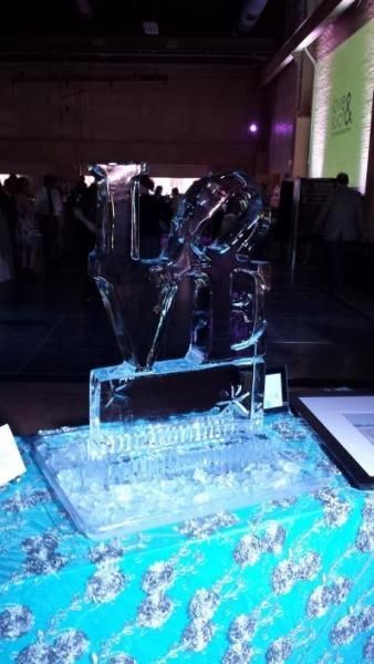 Small sculpture on a blue illuminated display table in a dimly lit room