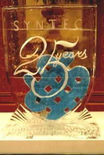 Decorative engraved glass trophy with “SYNTEX” and “20 years” in gold and blue