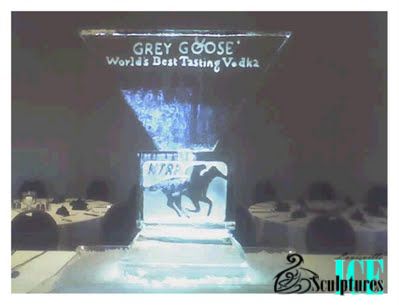 Grey Goose vodka display with ice sculpture and horse silhouette on a dimly lit stage