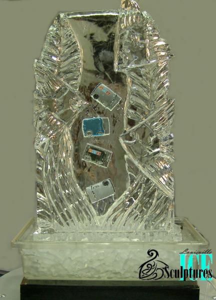 Clear glass award with a sculpted figure and blue accents on a stand