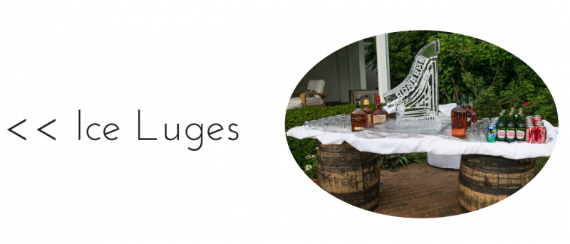 Ice luge setup with a white slide over wooden barrels in a snowy outdoor area