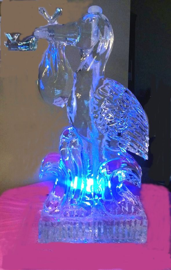 Blue-lit glass figurine of a woman playing a trumpet on a textured base