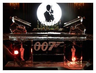 James Bond-themed display with 007 logo, a silhouetted figure, and two spotlit guns on a dark background