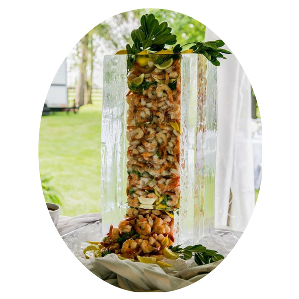 Tall clear vase of layered fruit salad on a table by a bright window