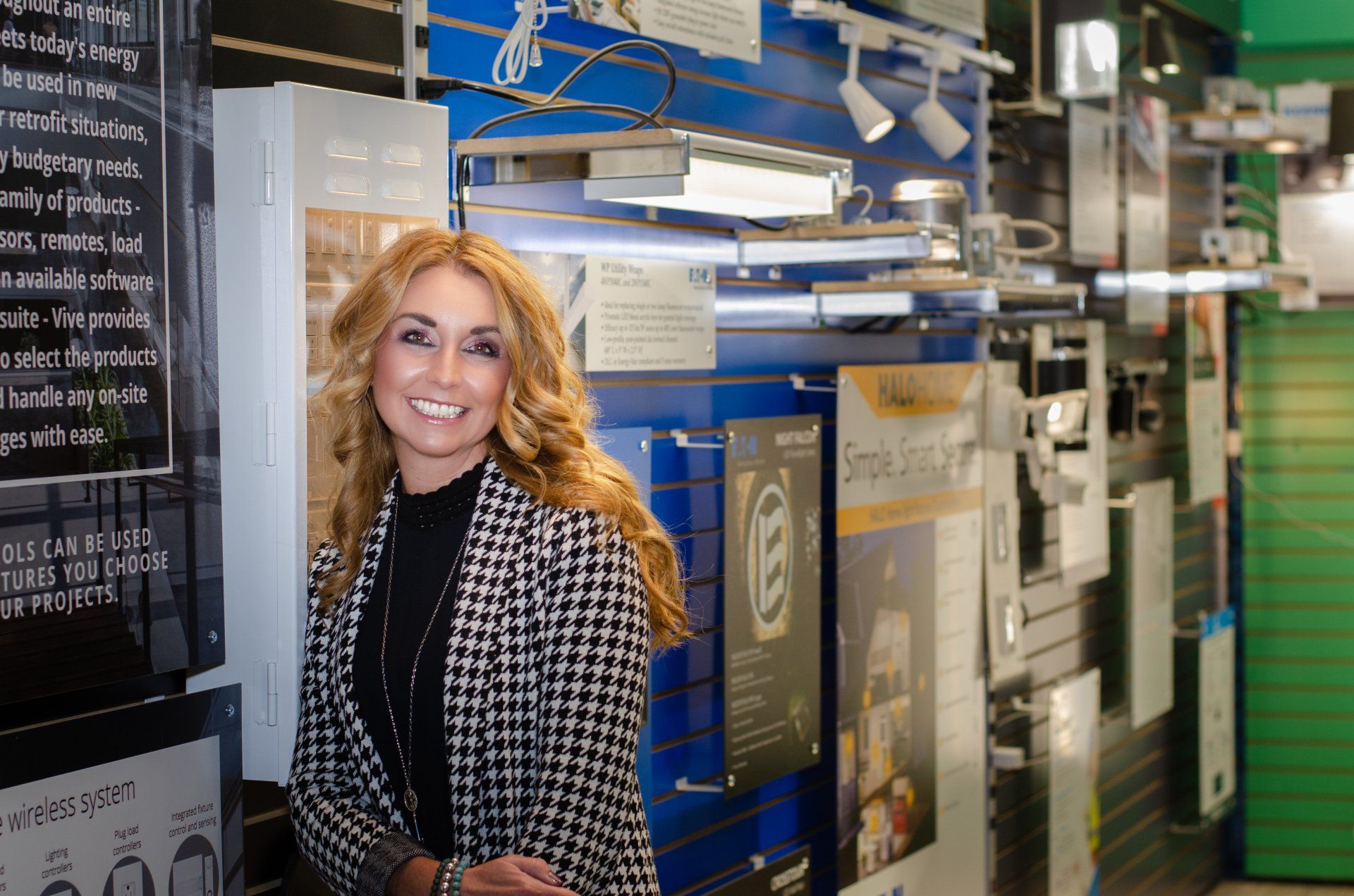 Tara Tomlinson stands next to a wall of electrical products